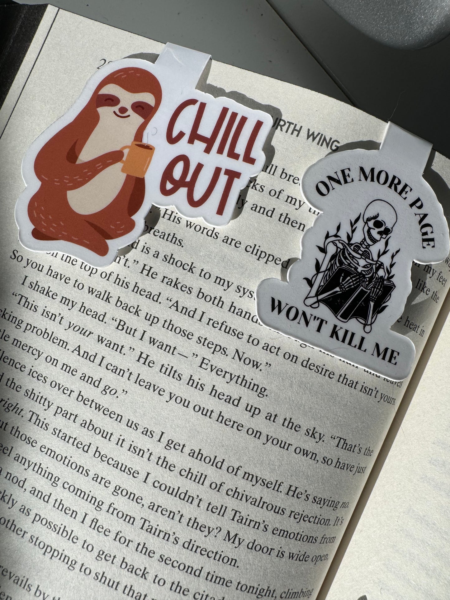 "One More Page Won't Kill Me" magnetic bookmark with a skeleton reading a book